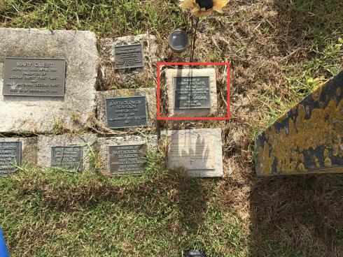 The plaque my friend had been asked to find. With several others between gravestones.
